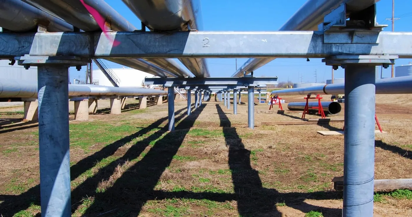 Pipe racks supported by helical piles